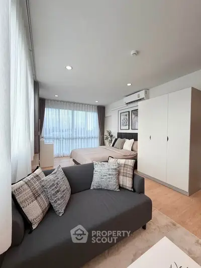 Modern studio apartment with cozy living area and stylish decor
