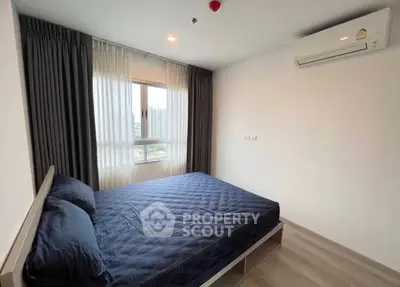 Modern bedroom with large window and air conditioning in a stylish apartment.