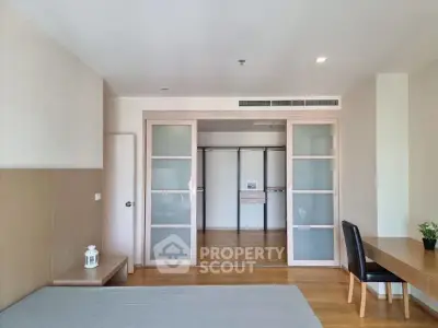 Spacious bedroom with sliding doors and modern decor in a stylish apartment.
