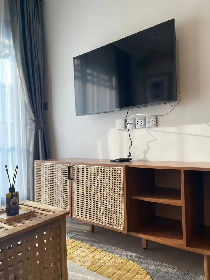 Modern living room with wall-mounted TV and stylish wooden furniture, perfect for cozy relaxation.