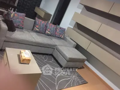 Modern living room with stylish gray sofa and decorative pillows