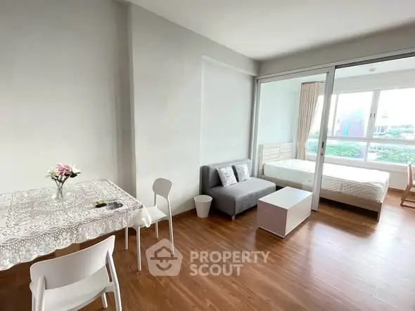 Modern studio apartment with open layout and wooden flooring