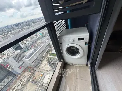 High-rise apartment balcony with washing machine and stunning city view