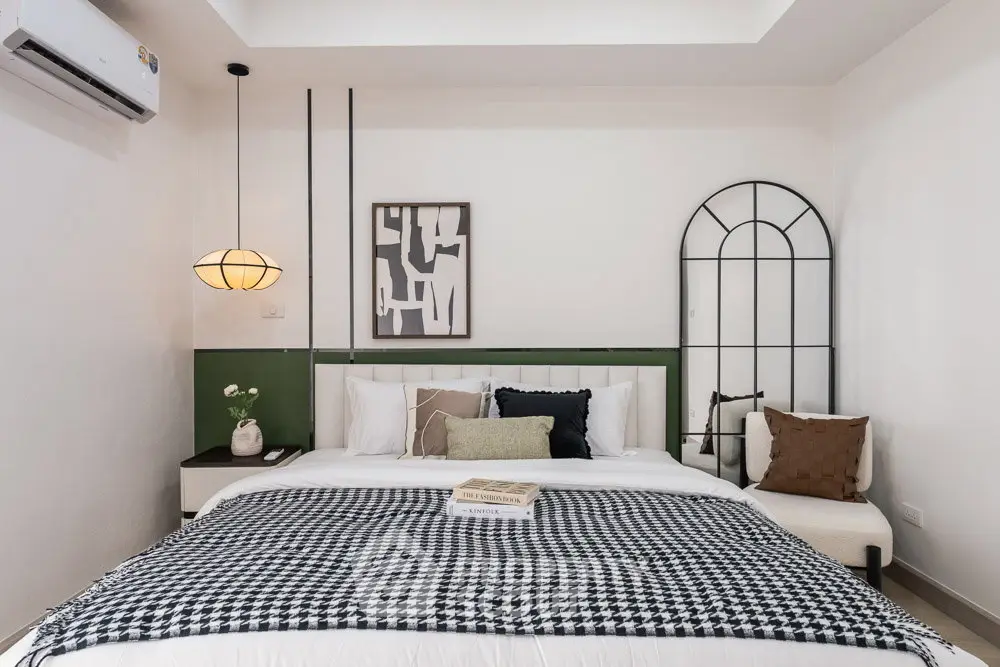 Stylish bedroom with modern decor and cozy ambiance, featuring a comfortable bed and chic wall art.