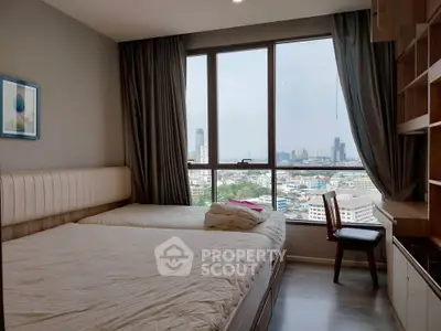 Cozy bedroom with city view, featuring a comfortable bed and elegant furnishings.