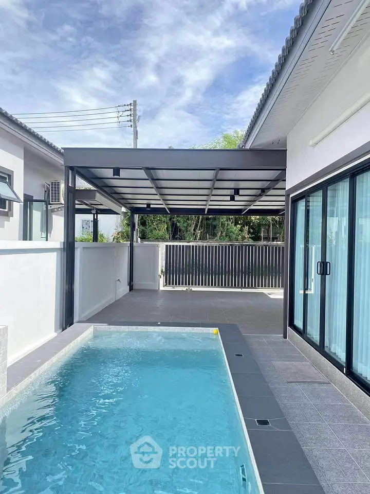 Modern home exterior with sleek pool and spacious patio area, perfect for relaxation and entertainment.