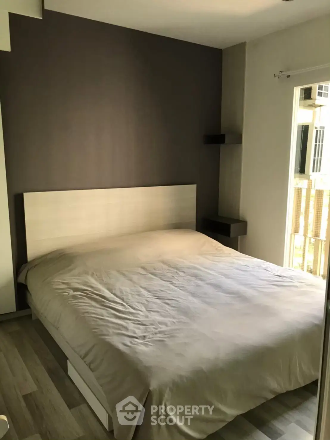 Cozy bedroom with modern design and natural light, perfect for relaxation and comfort.