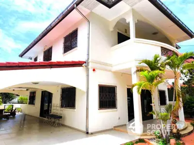 Stunning two-story white house with lush garden and spacious outdoor area.