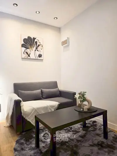 Cozy living room with modern decor and plush rug, perfect for relaxation.