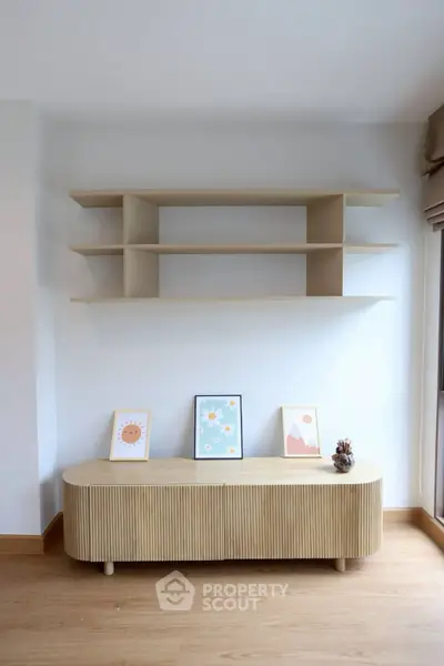 Modern minimalist living room with stylish wooden shelves and decor