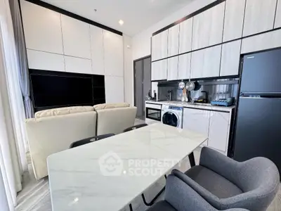 Modern open-plan living room with sleek kitchen and stylish furniture