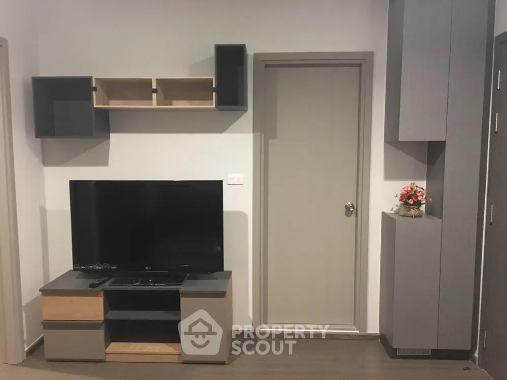 Modern living room with sleek TV stand and wall-mounted shelves, perfect for contemporary urban living.