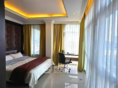 Luxurious bedroom with large windows and elegant decor in a modern apartment.