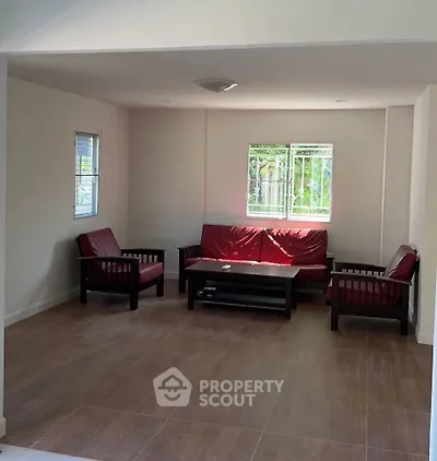 Spacious living room with modern furniture and large windows for natural light