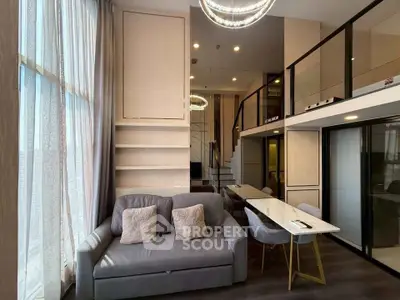 Modern loft apartment with high ceilings, large windows, and stylish interior design.