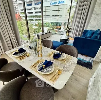 Luxurious dining area with elegant table setting and city view, perfect for modern living.