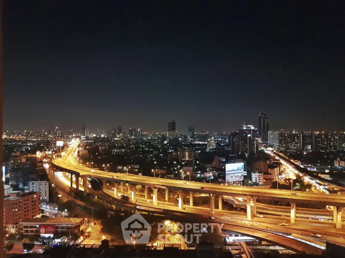 Stunning cityscape view with illuminated highways and skyline at night, perfect for urban living enthusiasts.