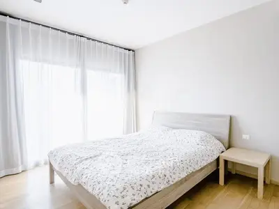 Bright and airy bedroom with large windows and modern decor