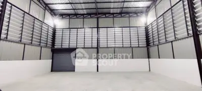 Spacious industrial warehouse with high ceilings and roller door access