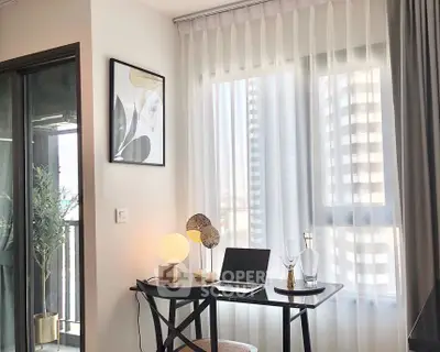 Chic modern study area with natural light and balcony view in urban apartment.