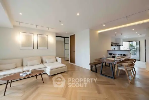 Spacious modern living room with open kitchen and elegant dining area.