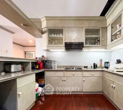 Spacious kitchen with modern appliances and wooden cabinetry