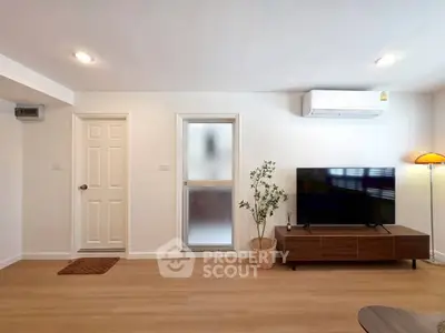 Modern living room with sleek TV unit and air conditioning