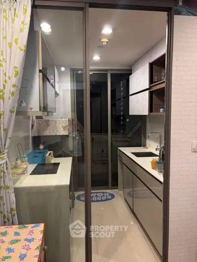 Modern compact kitchen with sleek design and glass sliding door