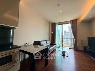 Modern living room with city view, sleek furniture, and open layout in high-rise apartment.