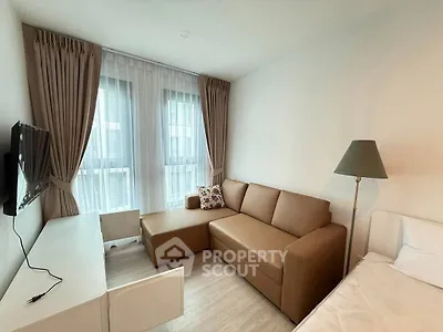 Modern living room with cozy sofa and natural light in stylish apartment.