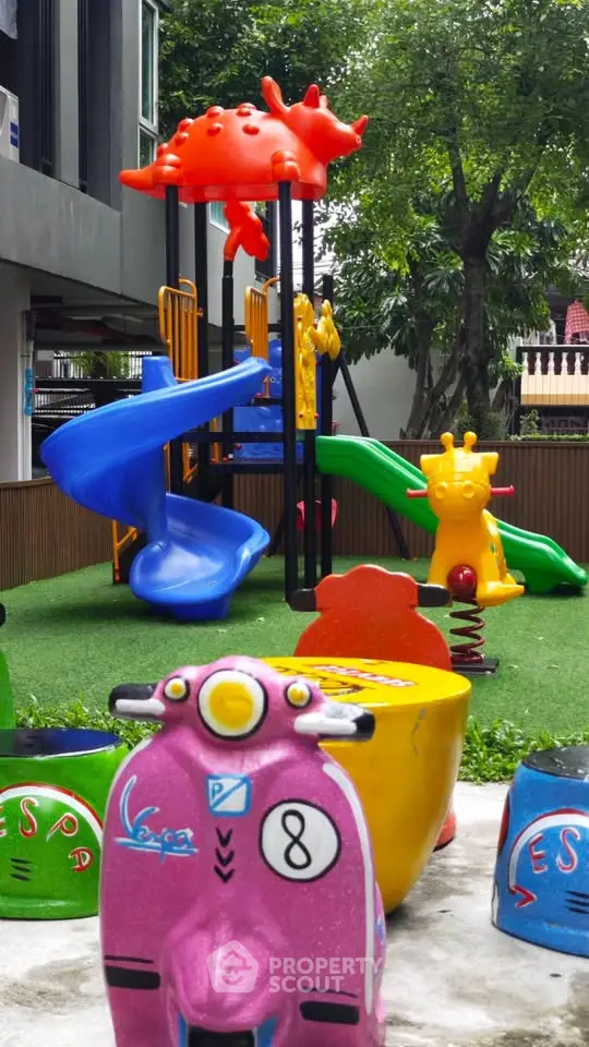 Vibrant children's playground with colorful slides and rides in a residential complex.