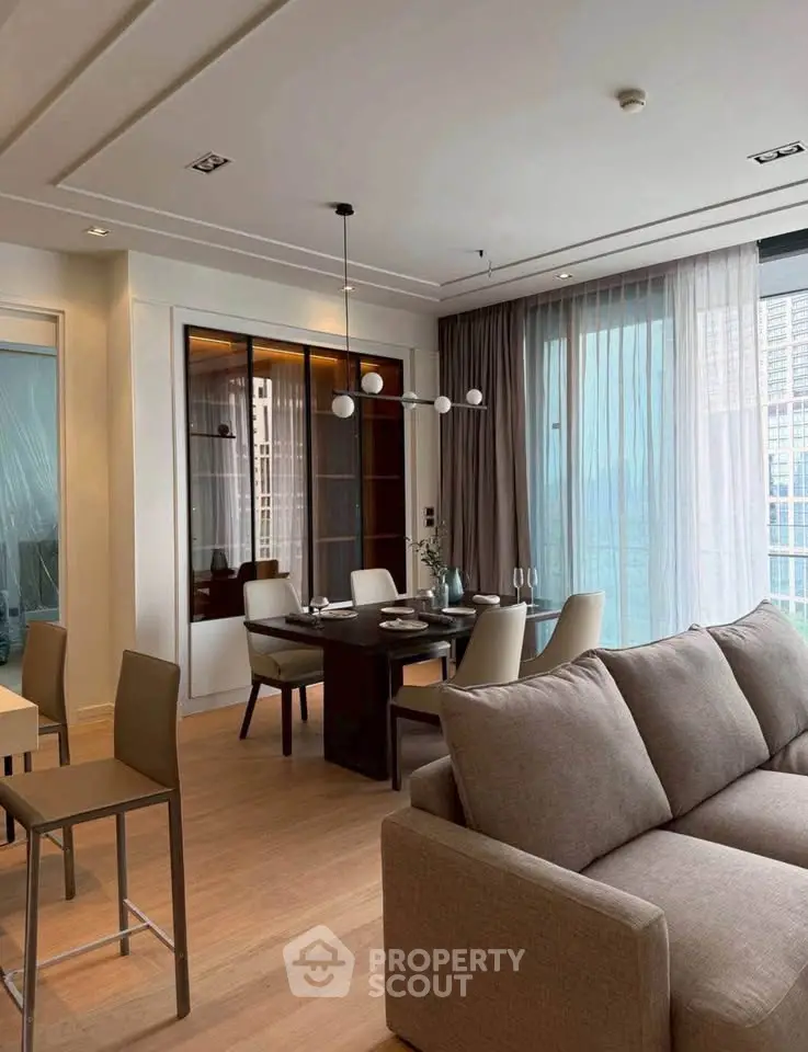Modern living room with elegant dining area and large windows in a luxury apartment.