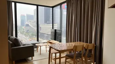 Modern living room with floor-to-ceiling windows offering stunning city views