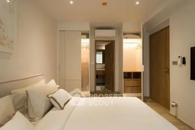 Modern bedroom with ensuite bathroom and stylish decor in a contemporary apartment.