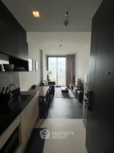Modern open-layout kitchen and living room with city view in high-rise apartment