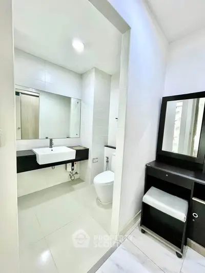 Modern bathroom with sleek design and vanity area, perfect for contemporary living.