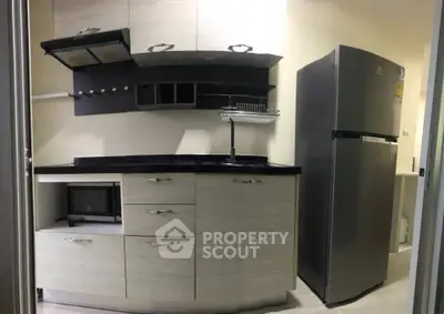 Modern kitchen with sleek cabinets and stainless steel fridge