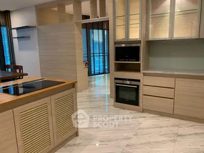 Modern kitchen with sleek cabinetry and marble flooring in a luxury apartment.