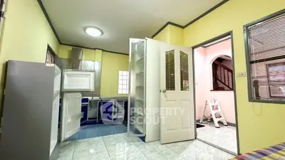 Charming kitchen with vibrant yellow walls and modern appliances in cozy home.