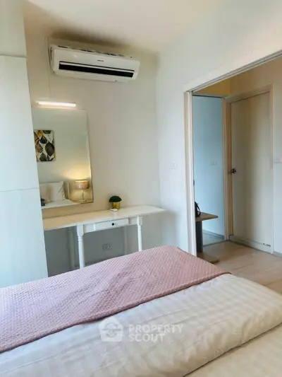 Cozy bedroom with air conditioning and stylish decor in modern apartment.