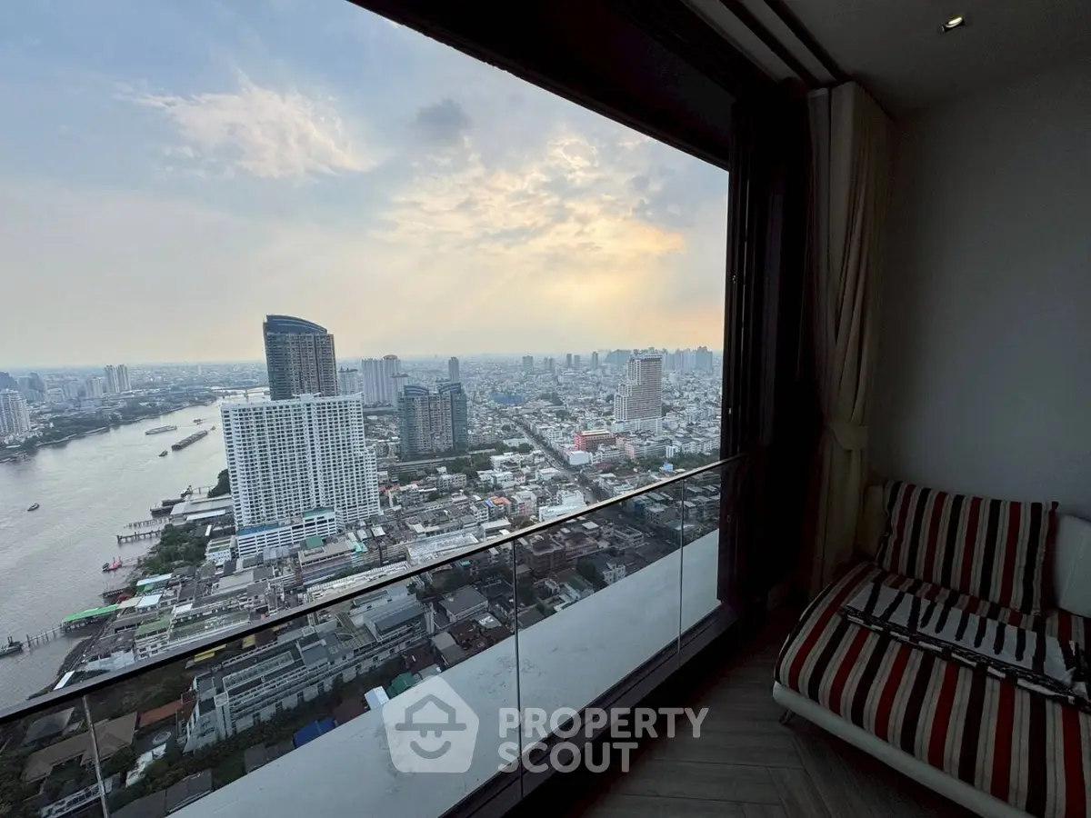 Stunning high-rise apartment with panoramic city and river views from a spacious balcony.