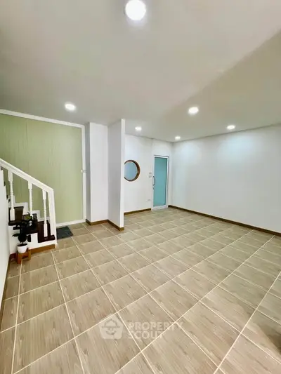 Spacious modern interior with elegant staircase and stylish tile flooring