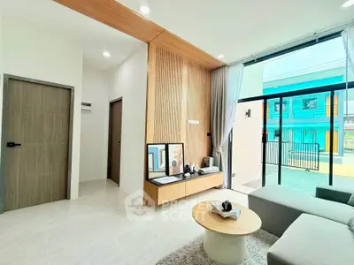 Modern living room with stylish decor and large windows offering natural light.