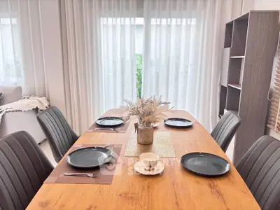 Elegant dining area with wooden table and stylish decor in modern home