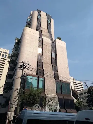 Modern high-rise building with unique architectural design in urban setting