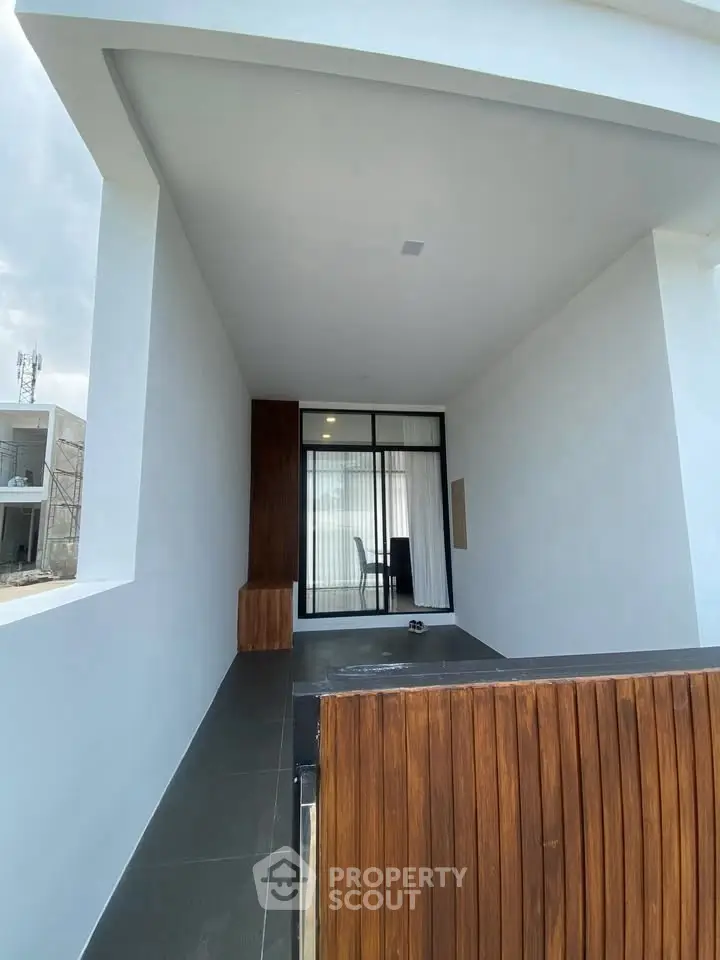 Modern minimalist exterior with sleek design and wooden accents, perfect for contemporary living.