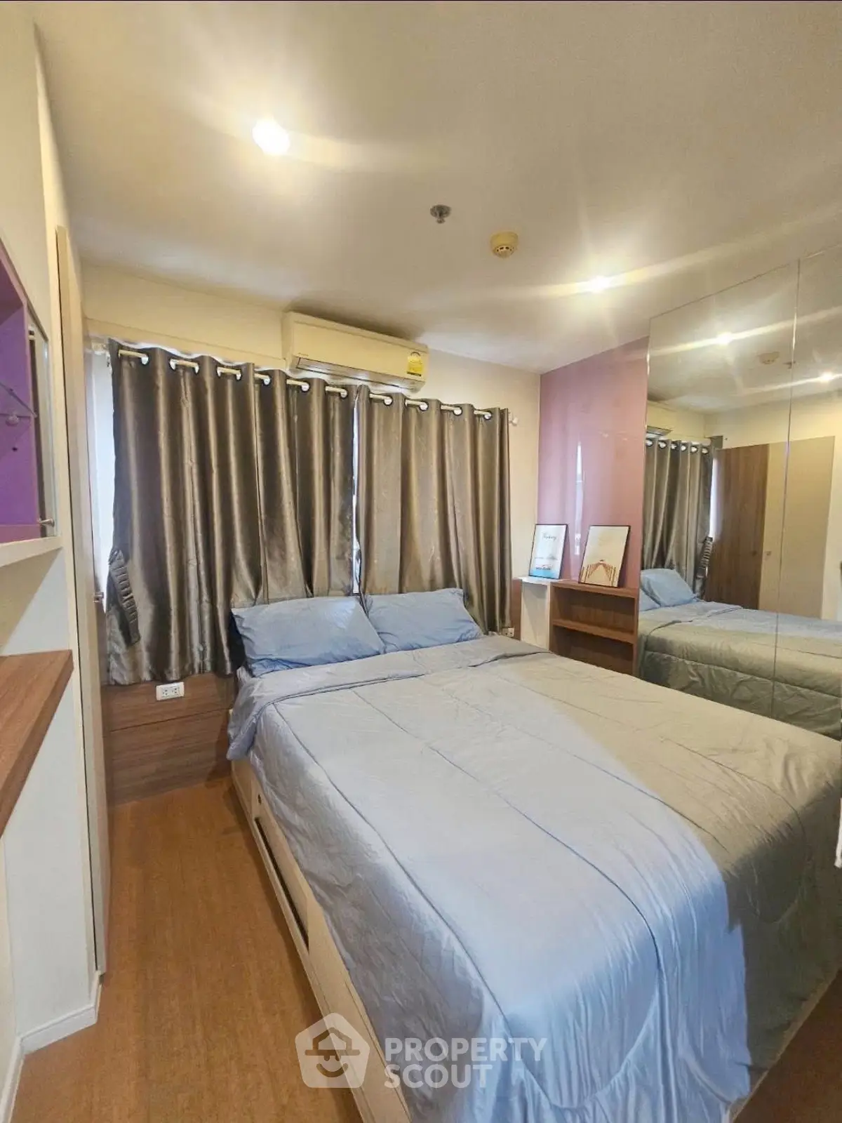 Cozy bedroom with modern decor and ample natural light