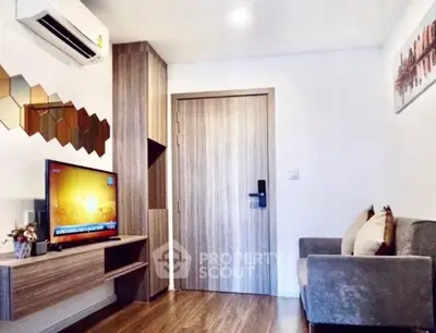 Modern living room with sleek design, featuring a wall-mounted TV and stylish decor.