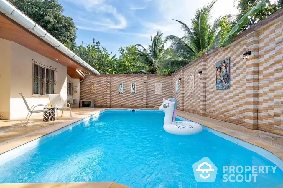 Charming private pool with tropical ambiance and cozy seating area