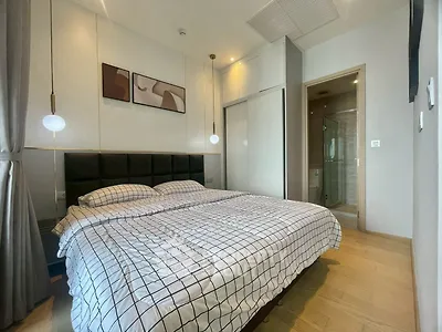 Modern bedroom with stylish decor and ensuite bathroom in luxury apartment